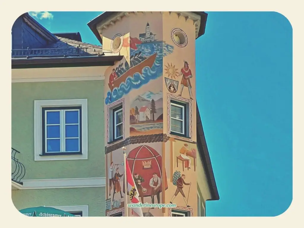 Murals on the upper part of a corner tower in Mozartplatz in St. Gilgen, Salzburg, Austria