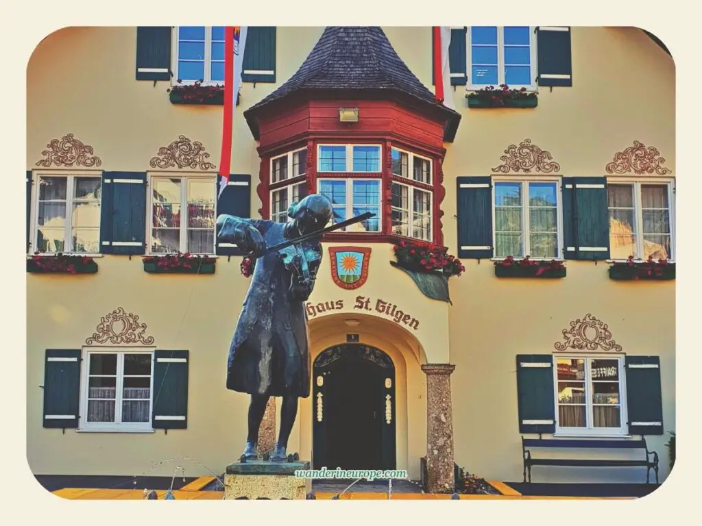 The statue of Mozart in front of St. Gilgen Town Hall’s facade, Salzburg, Austria