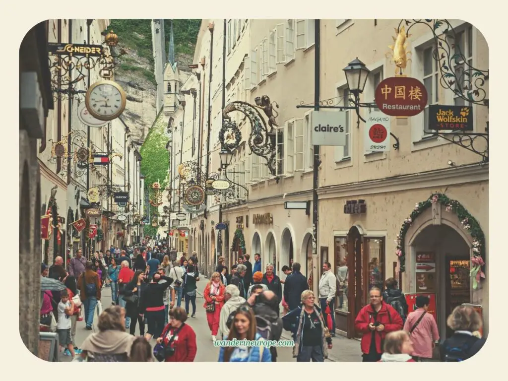 People window shopping on Getreidegasse, beautiful places in Salzburg, Austria
