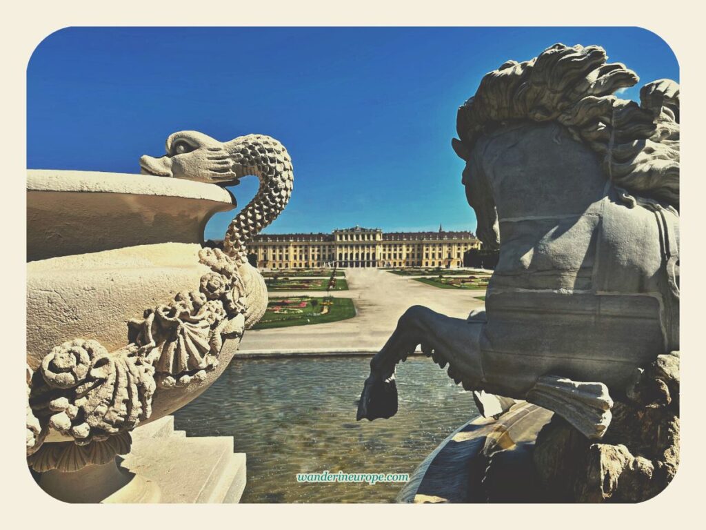 The main palace of Schönbrunn and the statues of the Neptune fountain, Vienna, Austria