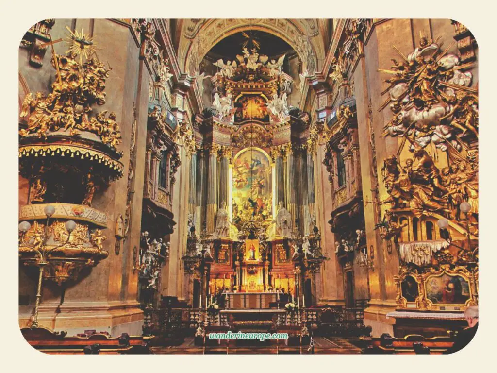 The pulpit, the high altar, and the golden sculpture of Peterskirche, Vienna, Austria