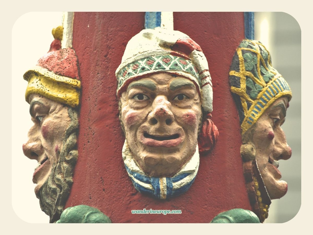 Sculptures of masks in Fritschibrunnen in Lucerne, Switzerland