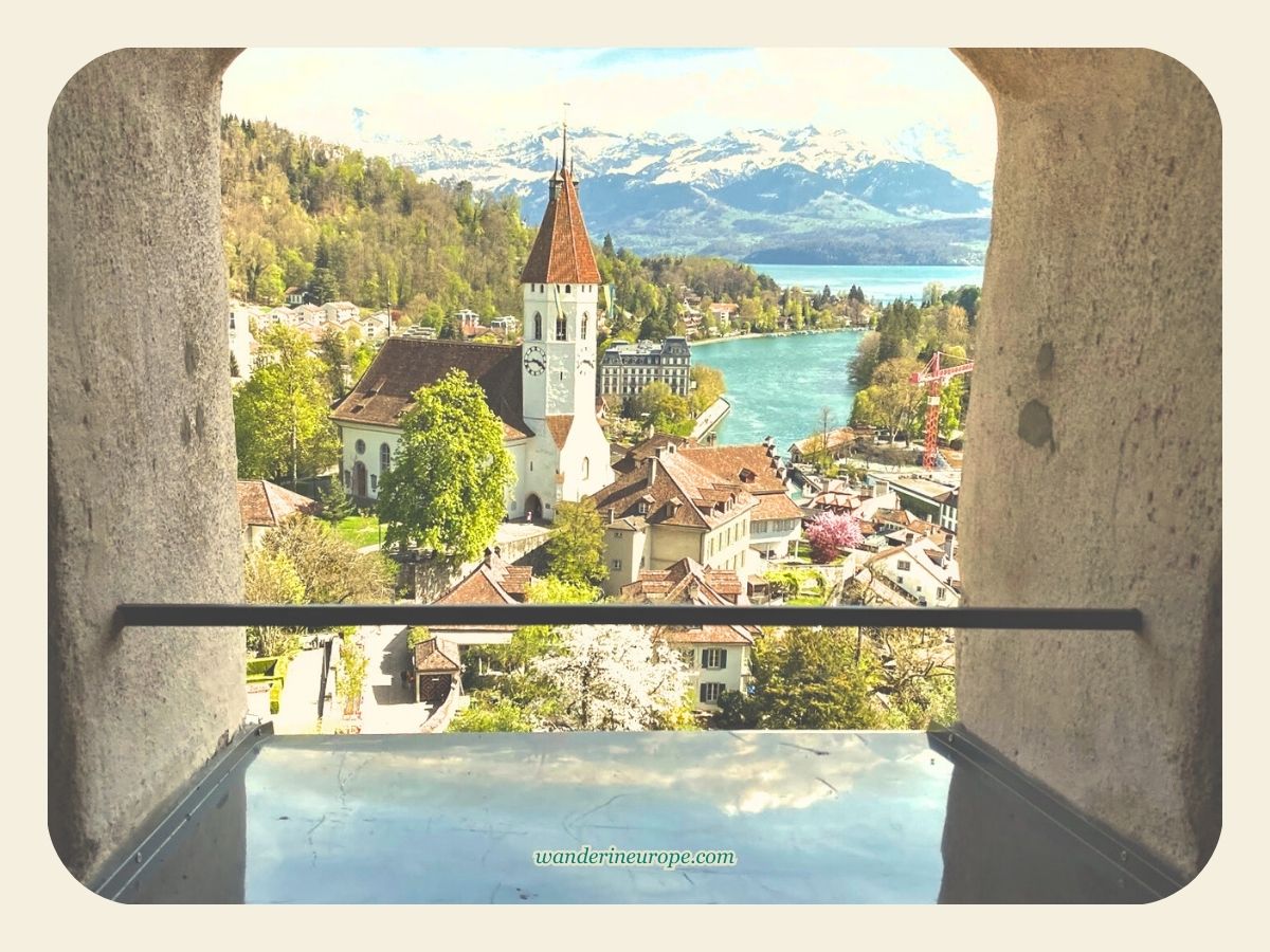 The view of Thun Central Church and the snowy peaks of Bernese Oberland from Thun Castle in Thun, Switzerland