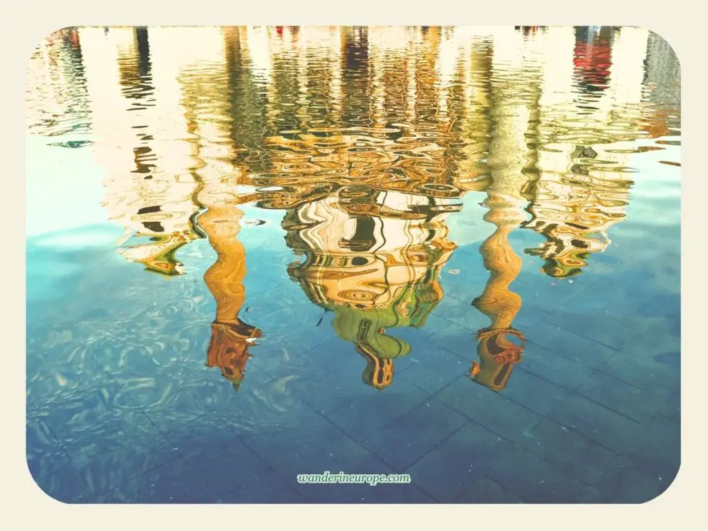 Water reflection in the front pond of Karlskirche, Vienna, Austria