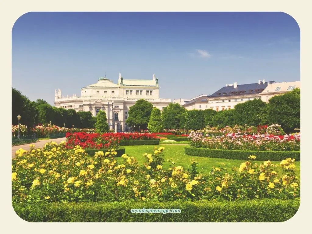 Burgtheater seen from the charming flowerbed of Volksgarten, beautiful attractions along Ringstrasse, Vienna, Austria